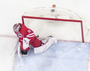 Cam Ward #30 Carolina Hurricanes goalie in RVH position as puck slides past him into the net, overhead view
