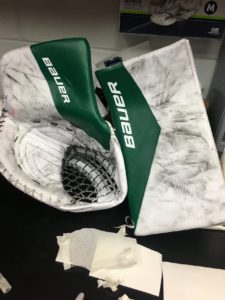 James Reimer Bauer glove and blocker in Hartford Whalers green and white colorway on equipment room floor
