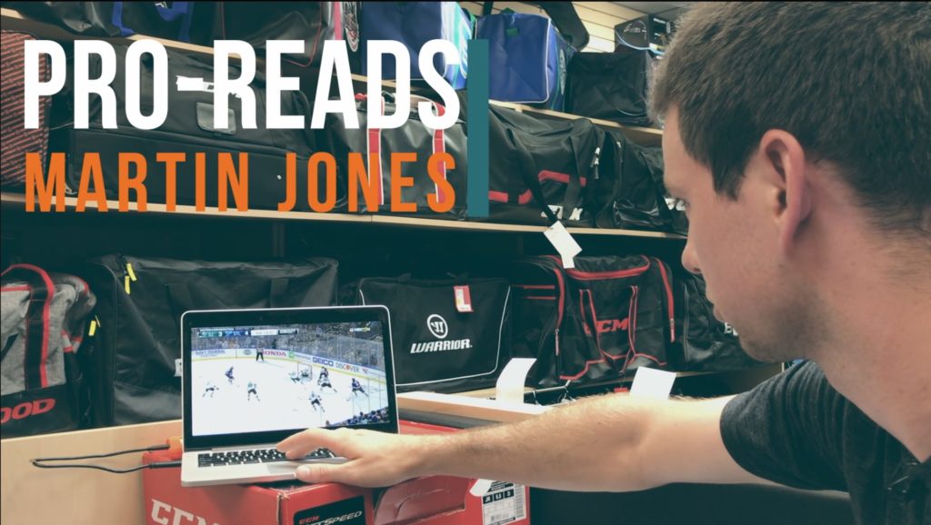 Martin Jones reviews game footage on a laptop in a locker room setting for InGoal Magazine's Pro-Reads series.