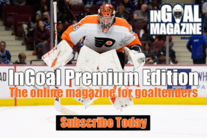 Philadelphia Flyers goalie Carter Hart in butterfly stance wearing orange pads and blocker, tracking puck during NHL game