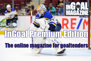 St. Louis Blues goalie Jake Allen in butterfly stance tracking the puck during an NHL game in full gear