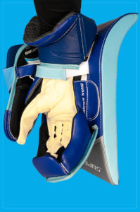 Blue and light blue goalie blocker held up showing palm side with yellow finger protection visible