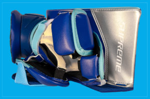 Bauer Supreme goalie blocker in blue and silver colorway, shown from palm-side interior view on blue background