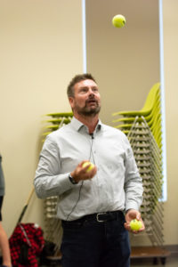 Goalie coach Stevenson juggling tennis balls indoors during a goaltender training drill