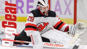 Mackenzie Blackwood #29 making a blocker save in New Jersey Devils white home pads and Bauer equipment