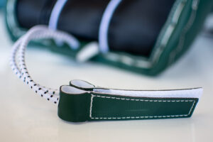 Close-up of green leather boot channel on CCM AXIS goalie skate showing stitching detail and lace guard