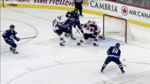 Mike Condon makes a backdoor save attempt as Ottawa Senators goalie scrambles across crease against Winnipeg Jets attackers
