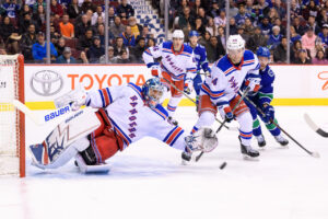 Henrik Lundqvist stretches in butterfly slide to make pad save for Rangers against Canucks at Rogers Arena, 2018
