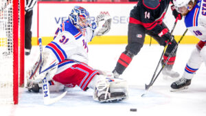 Igor Shesterkin #31 stretches into a butterfly slide to make a pad save for the New York Rangers against the Carolina Hurr...