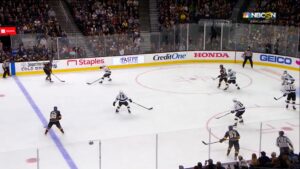 Cal Petersen reads play around a screen during an NHL game, positioned in his crease as Kings face the Golden Knights