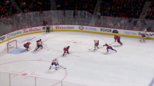 Carey Price in butterfly position protecting the near post as Canadiens defenders battle rush attackers in front of the cr...