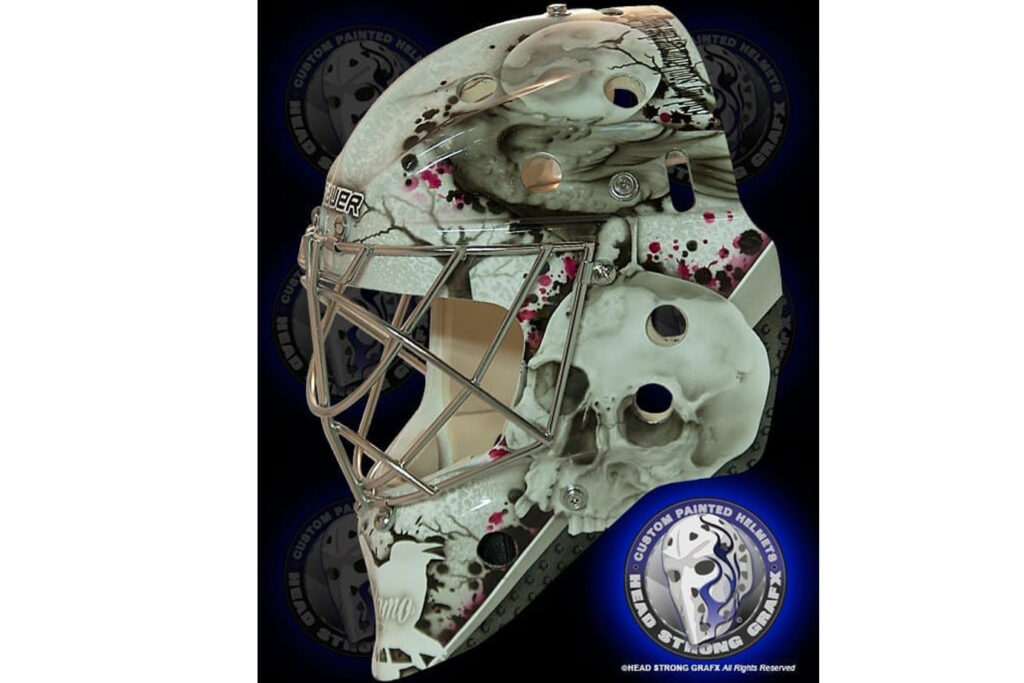 Karri Ramo goalie mask featuring horror-themed artwork with zombie figure and blood splatter on white base