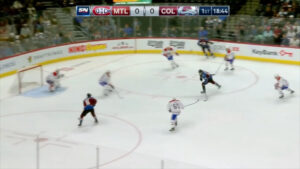 Carey Price in white Canadiens gear tracking play as Colorado sets up a backdoor pass attempt in the offensive zone