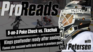 Cal Petersen LA Kings goalie in white mask and gear in butterfly stance during a 5-on-3 poke check drill