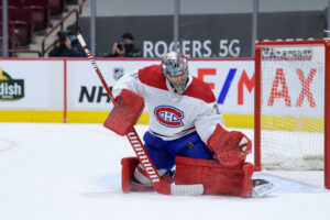 Carey Price makes a blocker save in butterfly position wearing Montreal Canadiens white pads and True goalie gear