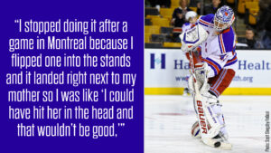 New York Rangers goalie Martin Biron in full gear stands on ice during a game, wearing blue Rangers uniform and mask