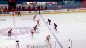 Jake Allen in net for Montreal Canadiens defending an odd-man rush situation, reading play from crease in red Habs jersey