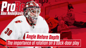 Alex Nedeljkovic #39 in Carolina Hurricanes white gear demonstrating rotation and angle positioning on a back-door play