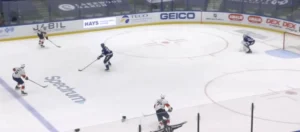Curtis McElhinney reads a 3-on-1 rush, positioning in crease as Tampa Bay defenders trail Florida Panthers attackers.