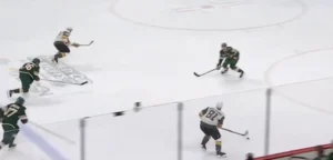 Cam Talbot reads a 2-on-1 rush, holding depth in crease as Wild defenders pressure Vegas forwards in NHL action.