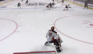 Ryan Miller #30 in Anaheim Ducks white jersey tracks a rush, holding edges at top of crease as play develops in neutral zone.