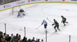 Cam Talbot makes a save in tight as Wild defenders pressure during 3-on-3 overtime action at Xcel Energy Center.