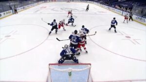 Curtis McElhinney in blue Lightning gear squares up in crease during a 3-on-1, tracking shooter with glove raised on rush