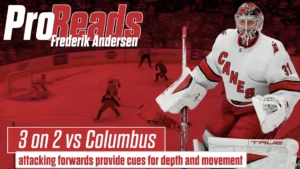 Frederik Andersen in Hurricanes red gear in butterfly stance during a 3-on-2 rush against Columbus