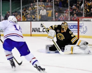 Tuukka Rask stretches to make a glove save for the Boston Bruins against a Montreal Canadiens shooter.