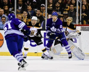 Tuukka Rask battles traffic as Maple Leafs forwards screen him in the crease during Bruins-Toronto NHL action