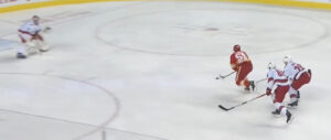 Freddie Andersen tracks a Detroit Red Wings skater on a breakaway as Rangers defenders pursue from behind.