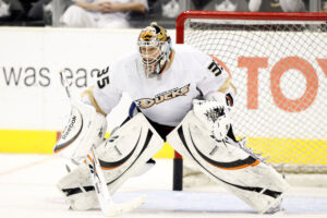 Anaheim Ducks goalie Jean-Sebastien Giguere in ready stance at Staples Center, wearing white Ducks pads and blocker, 2010.