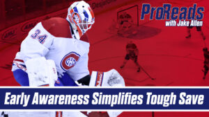 Jake Allen Montreal Canadiens goalie in butterfly stance tracking breakaway, wearing #34 white Habs jersey and red mask