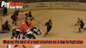 Anaheim Ducks goalie Ryan Miller tracks a low-to-high play, butterflying in his crease during an NHL game.