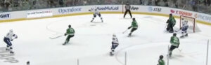 Scott Wedgewood in butterfly stance protecting the near post as Stars defenders battle Canucks attackers in front of the c...