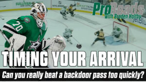 Stars goalie Braden Holtby in green gear challenges a backdoor pass attempt in tight during a ProReads drill