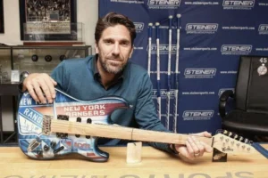 Henrik Lundqvist poses with a signed New York Rangers-themed electric guitar at a Steiner Sports memorabilia event.