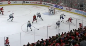 Thatcher Demko in crease during penalty kill, tracking puck as Canucks defenders pressure Red Wings attackers in the zone