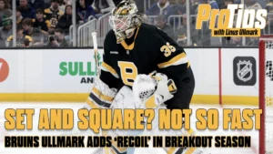 Linus Ullmark in butterfly stance, Boston Bruins black jersey #35, tracking puck in ready position on ice
