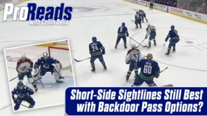 Collin Delia in blue Canucks gear tracking a backdoor pass option while screened in front of the crease