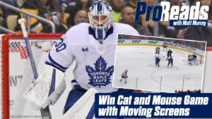 Toronto Maple Leafs goalie Matt Murray tracks play through a moving screen in his white Leafs pads and mask.