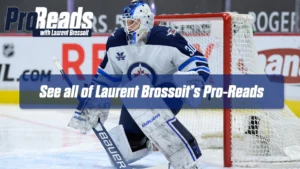 Laurent Brossoit in Winnipeg Jets gear making a lateral shuffle in butterfly stance during a rush save situation