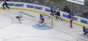 Jaroslav Halak makes a paddle-down save in tight as Rangers players converge on the crease during a scramble