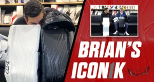 Goalie Casey DeSmith examines Brian's Iconik goalie pads up close, with equipment displayed in background