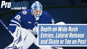 Toronto Maple Leafs goalie Joseph Woll in butterfly stance, blue mask and pads, defending wide rush in crease