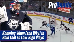 Jet Greaves in blue CCM gear tracks a low-high play sequence, with an in-game overhead view of a shooter in background