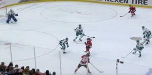 Devin Cooley squares up in his crease reading a rush, demonstrating depth and positioning with VH technique option visible