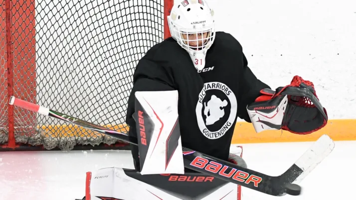 PWGoaltending coach demonstrates butterfly save in full Bauer gear during on-ice session in Oshawa, ON