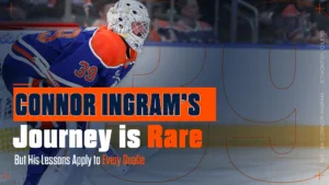 Connor Ingram in Edmonton Oilers blue jersey crouches in ready position wearing white goalie mask, number 39