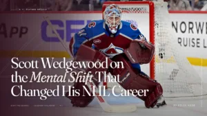 Scott Wedgewood in Colorado Avalanche gear in his crease, poised in butterfly stance ready to make a save.